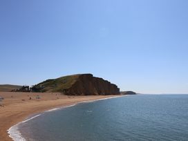 A beach with cliffs and people at Oakwood in Chideock