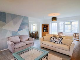 A living room with a sofa and coffee table at Oakwood in Chideock