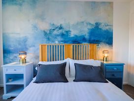 A bedroom with a bed and lamps at Oakwood in Chideock