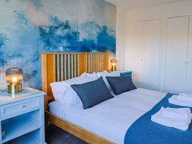 A bedroom with a bed and bedside tables at Oakwood in Chideock