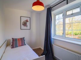 A bedroom with a bed and wall art at Oakwood in Chideock