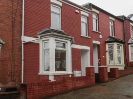 A red brick house exterior with multiple windows at Gavin and Stacey House in Barry