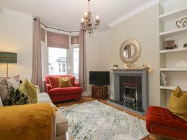 A living room with a sofa and armchairs at Gavin and Stacey House in Barry
