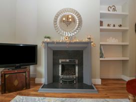 A living room with a fireplace and television at Gavin and Stacey House in Barry