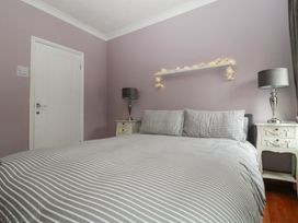 A bedroom with a bed and bedside tables at Gavin and Stacey House in Barry