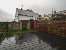 A garden with a house in the background at Gavin and Stacey House in Barry