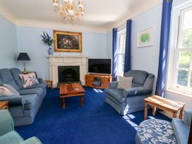 A living room with sofa and television at Ty Caredig in Swansea