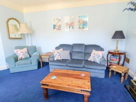 A living room with a sofa and chair at Ty Caredig in Swansea