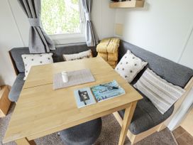 A dining area with a table and cushions at 31 Castle View in Lincoln