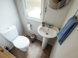 A bathroom with a toilet and sink at 31 Castle View Lincoln