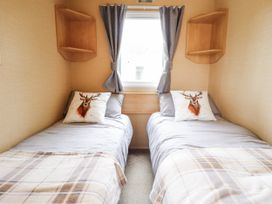 A bedroom with two beds and shelves at 31 Castle View in Lincoln