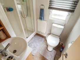 A bathroom with a shower, toilet, and sink at 31 Castle View in Lincoln