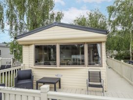 An outdoor view of a house with a deck and seating at 31 Castle View in Lincoln