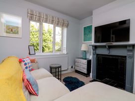 A living room with a sofa and television at Rockside in Salcombe