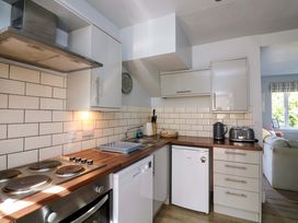 A kitchen with stove and refrigerator at Rockside in Salcombe