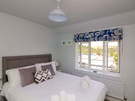 A bedroom with a bed and window at Rockside in Salcombe