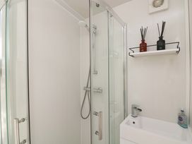 A bathroom with a shower and sink at Rockside in Salcombe