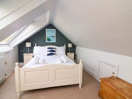 A bedroom with a bed and nightstands at Rockside in Salcombe