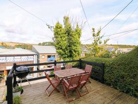 A deck with a table and chairs at Rockside in Salcombe