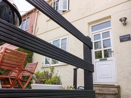 An outdoor area with a table and chairs at Rockside in Salcombe