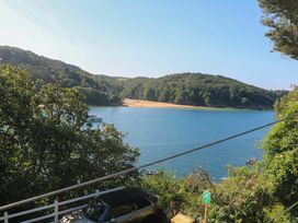 A view of a river with trees and sand at Rockside in Salcombe