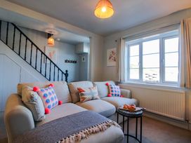 A living room with a sofa and coffee table at Rockside in Salcombe