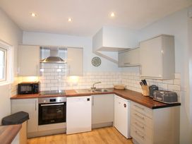 A kitchen with appliances and countertops at Rockside in Salcombe