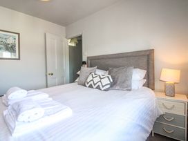 A bedroom with a bed and bedside table at Rockside in Salcombe