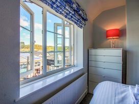 A bedroom with a window and chest of drawers at Rockside in Salcombe