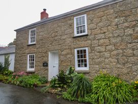 A stone cottage with plants in front at 1 Rowes Cottages Penzance