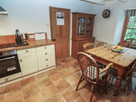 A kitchen with a table and chairs at 1 Rowes Cottages Penzance