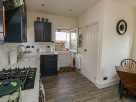 A kitchen with a sink and stove at 13 School Road Newton Abbot