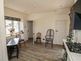 A kitchen with a table and chairs at 13 School Road in Newton Abbot