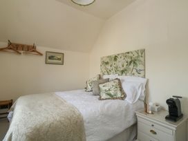 A bedroom with a bed and coffee maker at 13 School Road in Newton Abbot