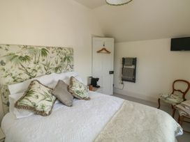 A bedroom with a bed and television at 13 School Road Newton Abbot
