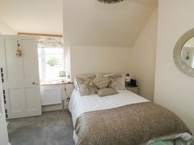 A bedroom with a bed and window at 13 School Road in Newton Abbot
