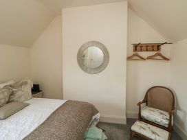 A bedroom with a bed and a chair at 13 School Road in Newton Abbot