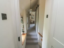 A hallway with a ceiling light and mirror at 13 School Road Newton Abbot