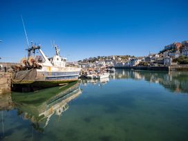 A harbor with fishing boats and houses at 13 School Road in Kingskerswell