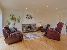 A living room with a fireplace and seating at Hawksdown in Lyme Regis