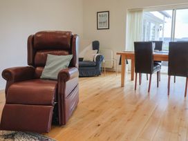 A living room with a reclining chair and dining table at Hawksdown in Lyme Regis