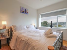 A bedroom with a bed and a bedside table at Hawksdown in Lyme Regis