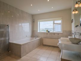A bathroom with a bathtub and sink at Hawksdown in Lyme Regis