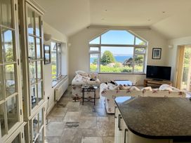 A living room with a sofa and a television at Hawksdown in Lyme Regis