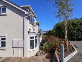 An exterior view of a house with a pathway and plants at Hawksdown Lyme Regis