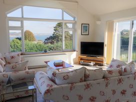 A living room with a sofa and TV at Hawksdown in Lyme Regis