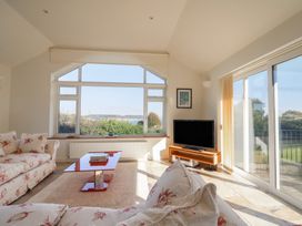 A living room with a sofa and a television at Hawksdown in Lyme Regis