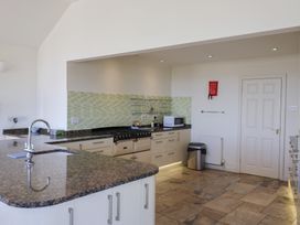 A kitchen with cabinets and appliances at Hawksdown in Lyme Regis