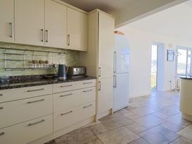 A kitchen with cabinets and appliances at Hawksdown in Lyme Regis