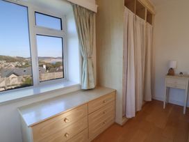 A bedroom with a window and a dresser at Hawksdown in Lyme Regis
